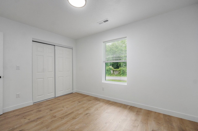 1620 N Texas Ave, Springfield, MO 65803 - unfurnished bedroom with baseboards, light wood-type flooring, and a closet