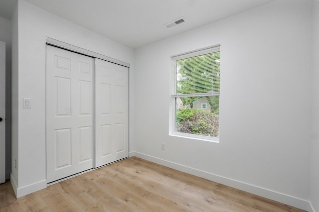 1620 N Texas Ave, Springfield, MO 65803 - unfurnished bedroom with baseboards, light wood-type flooring, and a closet