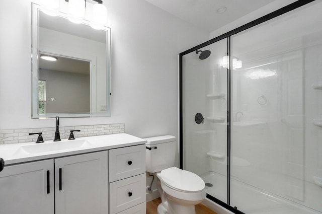 1620 N Texas Ave, Springfield, MO 65803 - full bath with a stall shower, tasteful backsplash, toilet, vanity, and wood finished floors