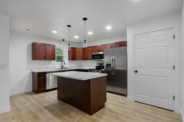 1620 N Texas Ave, Springfield, MO 65803 - kitchen featuring appliances with stainless steel finishes, a sink, light wood-style floors, pendant lighting, and recessed lighting