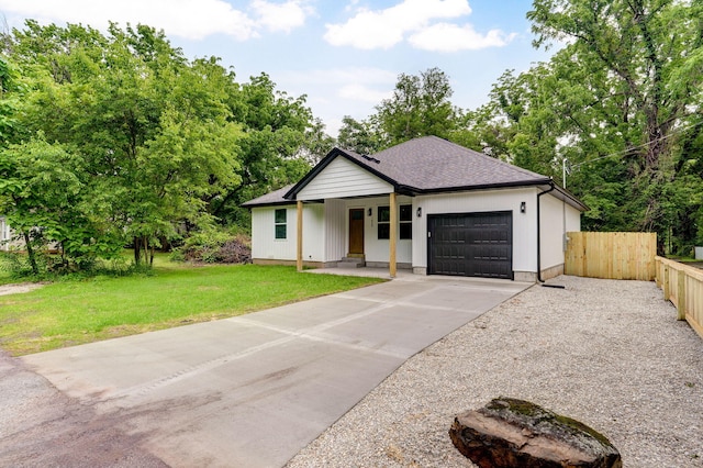 1620 N Texas Ave, Springfield, MO 65803 - view of front facade featuring a garage, concrete driveway, and view of scattered trees