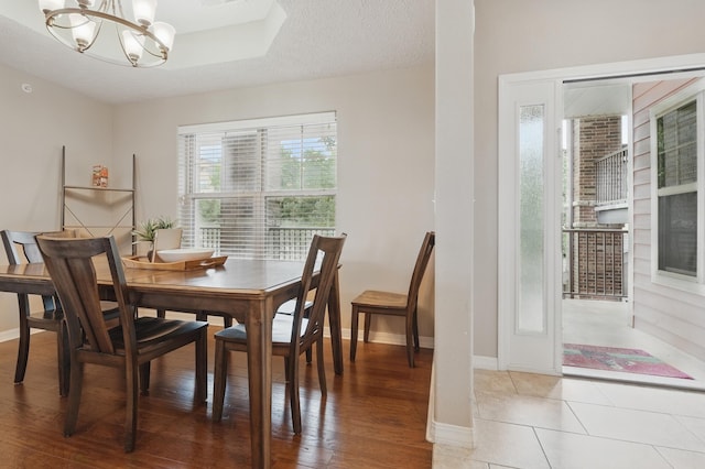 200 Majestic Dr Unit 1-208, Branson, MO 65616 - dining area featuring a chandelier, baseboards, and light wood-style flooring