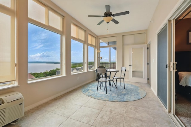200 Majestic Dr Unit 1-208, Branson, MO 65616 - sunroom / solarium with a water view, tile patterned floors, baseboards, and a wall mounted air conditioner