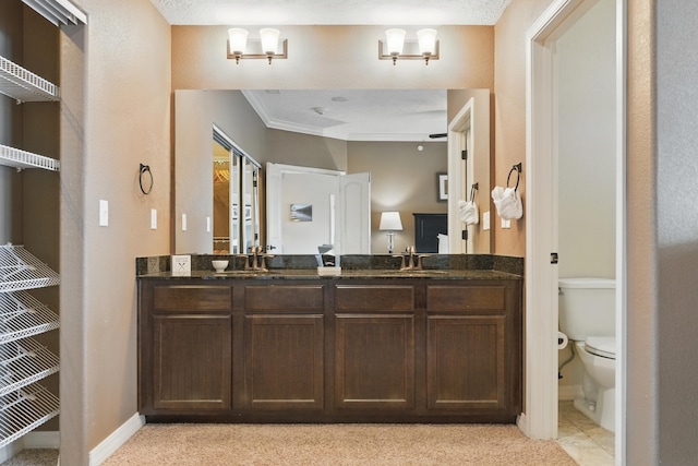 200 Majestic Dr Unit 1-208, Branson, MO 65616 - bathroom featuring toilet, double vanity, baseboards, and crown molding