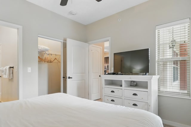 200 Majestic Dr Unit 1-208, Branson, MO 65616 - bedroom with baseboards, multiple windows, a spacious closet, and ceiling fan