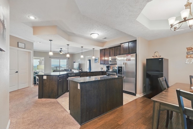 200 Majestic Dr Unit 1-208, Branson, MO 65616 - kitchen featuring stainless steel appliances, dark brown cabinetry, a peninsula, dark countertops, and a chandelier