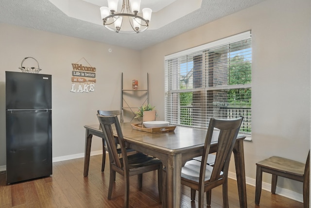 200 Majestic Dr Unit 1-208, Branson, MO 65616 - dining area featuring a chandelier, wood finished floors, baseboards, and a textured ceiling