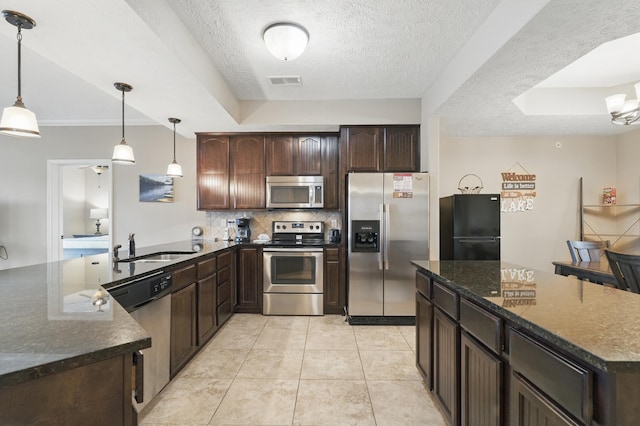 200 Majestic Dr Unit 1-208, Branson, MO 65616 - kitchen with stainless steel appliances, tasteful backsplash, a sink, a textured ceiling, and dark brown cabinetry