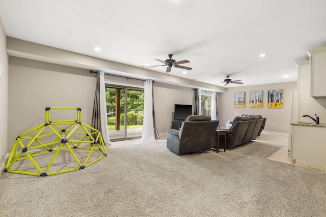 5142 S Burrows Ave, Springfield, MO 65810 - carpeted living room featuring recessed lighting, plenty of natural light, ceiling fan, baseboards, and a sink