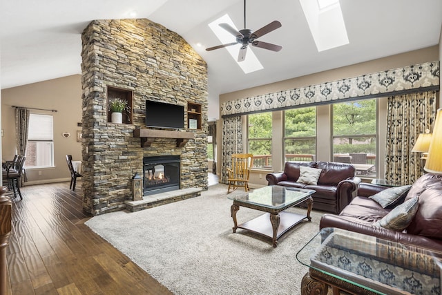 5142 S Burrows Ave, Springfield, MO 65810 - living room with hardwood / wood-style flooring, a ceiling fan, a skylight, a fireplace, and healthy amount of natural light