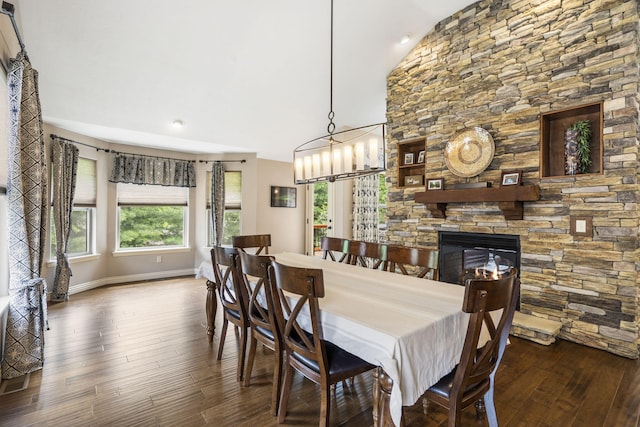 5142 S Burrows Ave, Springfield, MO 65810 - dining area with plenty of natural light, wood finished floors, a chandelier, vaulted ceiling, and a stone fireplace