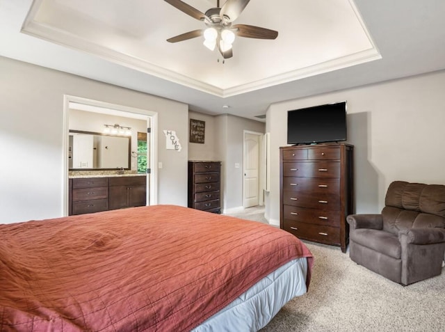 5142 S Burrows Ave, Springfield, MO 65810 - bedroom with a raised ceiling, light colored carpet, ensuite bath, a sink, and a ceiling fan