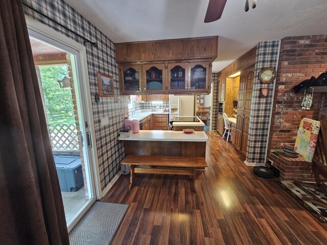 22389 Lawrence Unit 1215, Aurora, MO 65605 - dining space with wallpapered walls, a textured ceiling, a ceiling fan, and dark wood finished floors