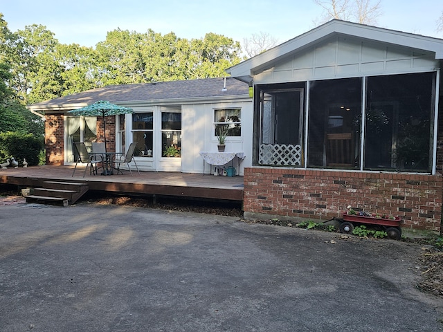 22389 Lawrence Unit 1215, Aurora, MO 65605 - back of house featuring brick siding, a deck, a sunroom, and board and batten siding