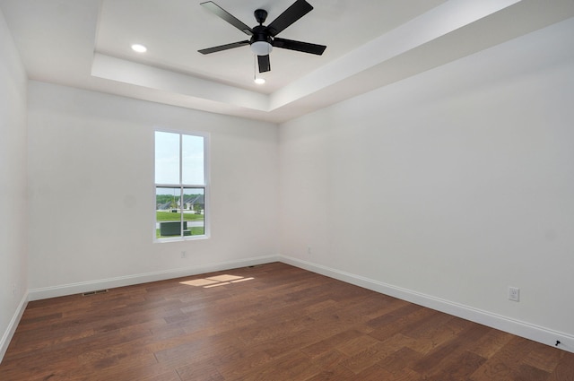 1698 N Marlowe Ave, Springfield, MO 65802 - empty room featuring dark wood finished floors, a raised ceiling, baseboards, recessed lighting, and ceiling fan