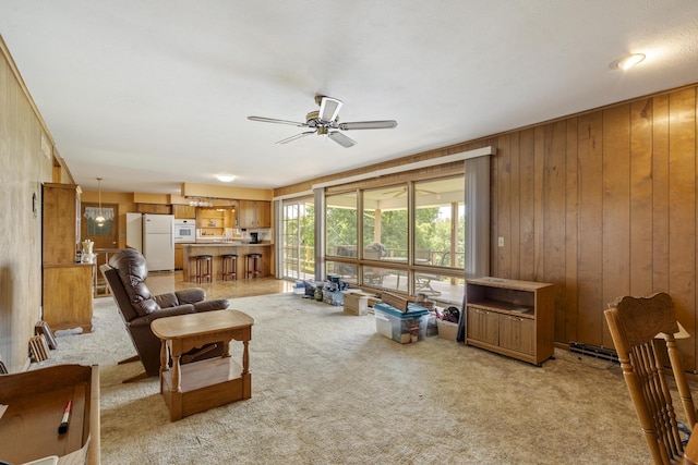 39 James River Rd, Kimberling City, MO 65686 - living room featuring light carpet, ceiling fan, and wood walls