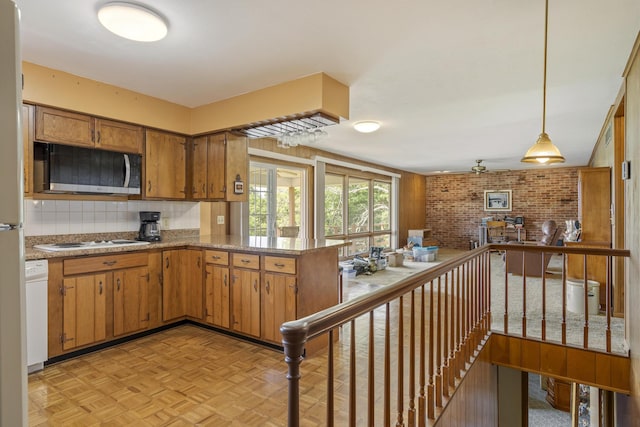 39 James River Rd, Kimberling City, MO 65686 - kitchen featuring white appliances, brown cabinets, pendant lighting, decorative backsplash, and brick wall