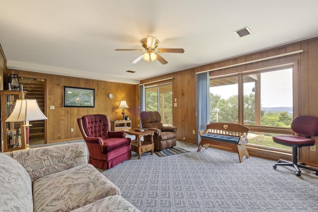 39 James River Rd, Kimberling City, MO 65686 - carpeted living area featuring wooden walls and a ceiling fan