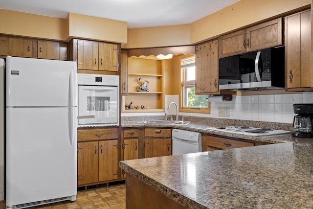 39 James River Rd, Kimberling City, MO 65686 - kitchen with white appliances, open shelves, dark countertops, a sink, and brown cabinetry