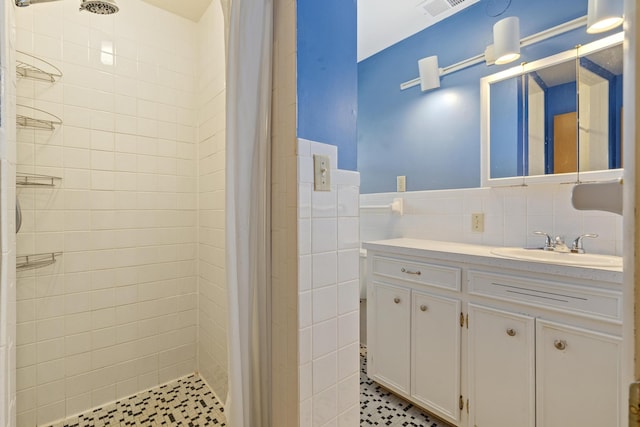 39 James River Rd, Kimberling City, MO 65686 - bathroom featuring tile walls, tiled shower, vanity, and a wainscoted wall