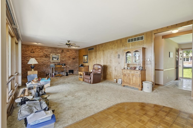 39 James River Rd, Kimberling City, MO 65686 - living room with wooden walls, ceiling fan, baseboards, and a wood stove