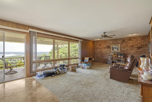 39 James River Rd, Kimberling City, MO 65686 - living room with ceiling fan, wooden walls, and brick wall