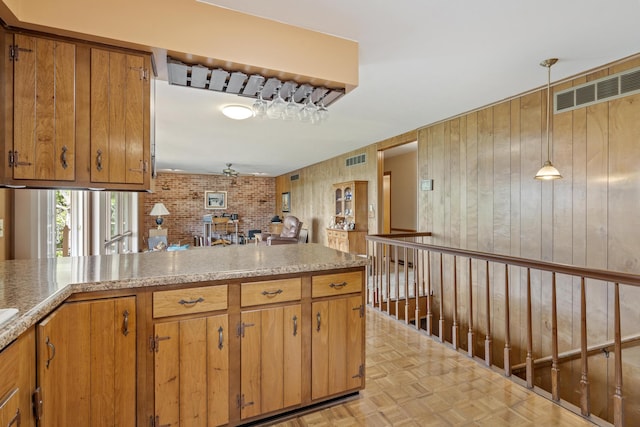 39 James River Rd, Kimberling City, MO 65686 - kitchen with brown cabinets, light countertops, and hanging light fixtures