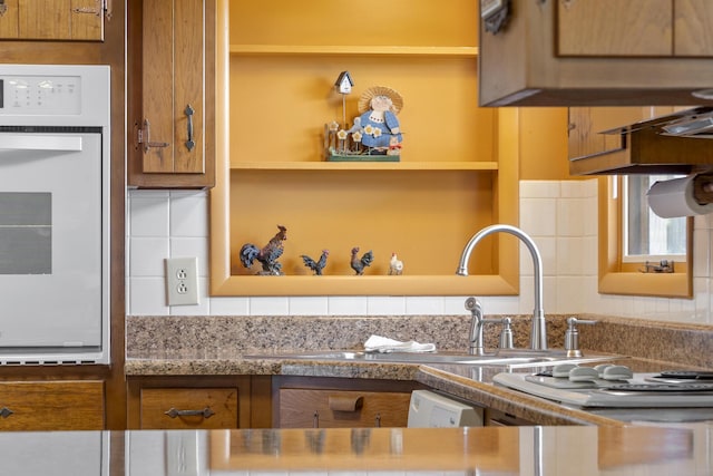 39 James River Rd, Kimberling City, MO 65686 - kitchen with oven, brown cabinetry, tasteful backsplash, and open shelves
