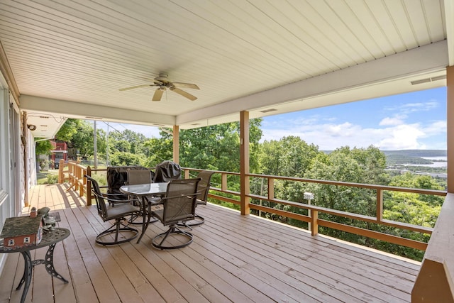 39 James River Rd, Kimberling City, MO 65686 - wooden deck with a ceiling fan, outdoor dining space, and view of scattered trees