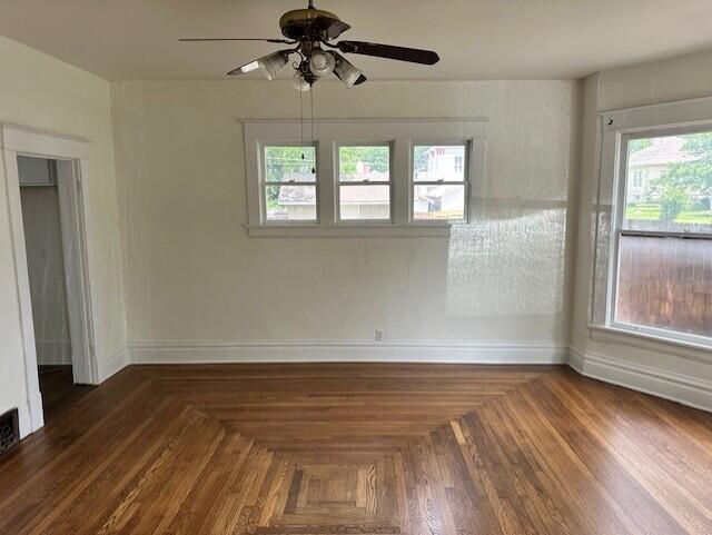 1052 S Garrison Ave, Carthage, MO 64836 - unfurnished room featuring a ceiling fan, baseboards, and healthy amount of natural light