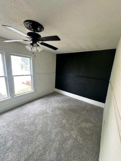 1052 S Garrison Ave, Carthage, MO 64836 - empty room with carpet floors, ceiling fan, and a textured ceiling