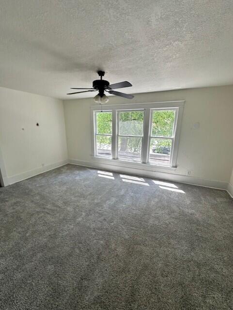 1052 S Garrison Ave, Carthage, MO 64836 - spare room featuring a ceiling fan, carpet, a textured ceiling, and baseboards