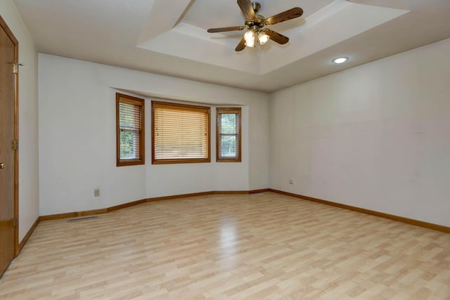 299 Regal Dr, Rogersville, MO 65742 - spare room with light wood-style flooring, a tray ceiling, baseboards, a ceiling fan, and recessed lighting
