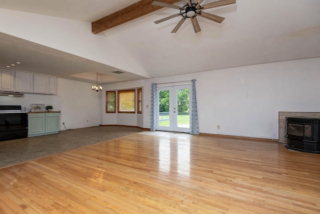 299 Regal Dr, Rogersville, MO 65742 - unfurnished living room with a chandelier, a wood stove, beam ceiling, light wood finished floors, and ceiling fan