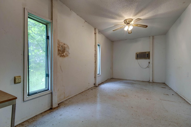 299 Regal Dr, Rogersville, MO 65742 - unfurnished room featuring healthy amount of natural light, a wall unit AC, a ceiling fan, concrete floors, and a textured ceiling