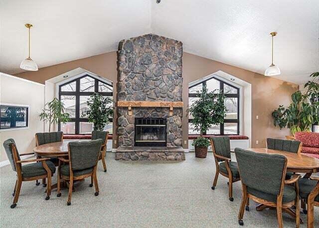 350 S Wildwood Dr Unit B-11, Branson, MO 65616 - carpeted dining space featuring vaulted ceiling and a fireplace