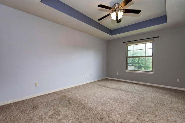 5048 S Fieldstone Rd, Battlefield, MO 65619 - carpeted spare room with baseboards, a tray ceiling, and ceiling fan