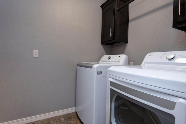 5048 S Fieldstone Rd, Battlefield, MO 65619 - laundry room with cabinet space, washing machine and clothes dryer, and baseboards