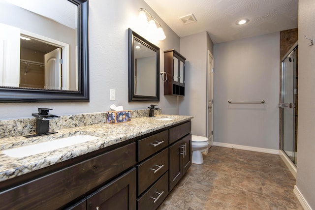 5048 S Fieldstone Rd, Battlefield, MO 65619 - full bathroom featuring baseboards, double vanity, toilet, and a stall shower