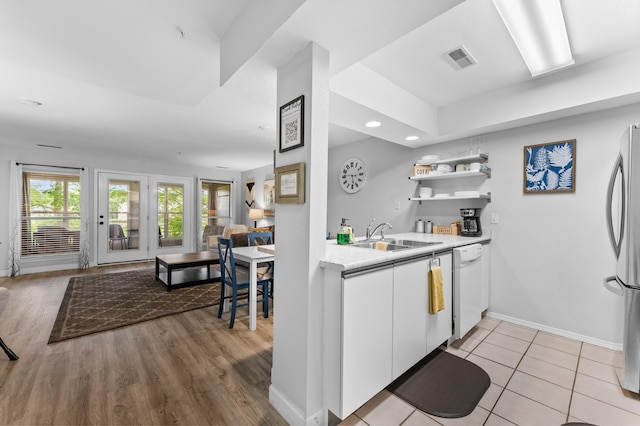 200 Golf View Dr Unit 3, Branson, MO 65616 - kitchen featuring a sink, freestanding refrigerator, white dishwasher, white cabinetry, and light countertops