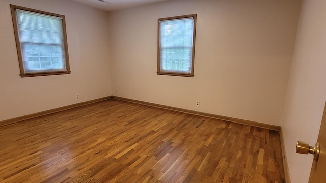 415 N Locust St, Marshfield, MO 65706 - empty room with wood finished floors and baseboards