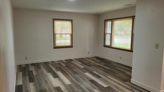 415 N Locust St, Marshfield, MO 65706 - empty room with dark wood finished floors, a textured ceiling, and baseboards
