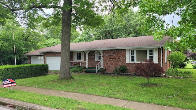 415 N Locust St, Marshfield, MO 65706 - ranch-style home featuring a garage, brick siding, a front yard, and covered porch
