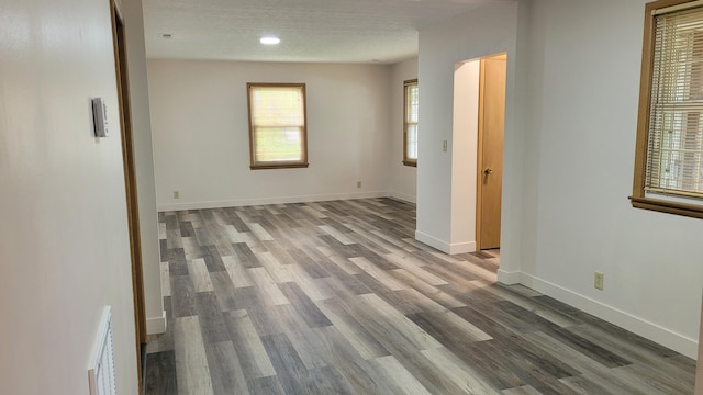 415 N Locust St, Marshfield, MO 65706 - spare room with wood finished floors, baseboards, and recessed lighting