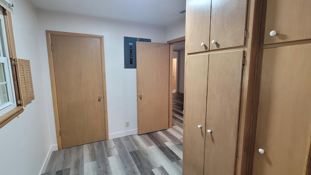 415 N Locust St, Marshfield, MO 65706 - unfurnished bedroom with electric panel, wood finished floors, and baseboards