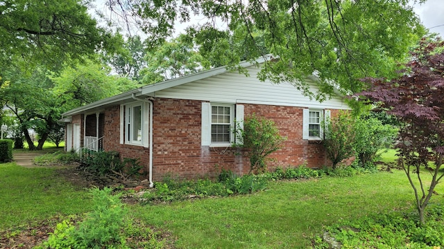 415 N Locust St, Marshfield, MO 65706 - view of side of home with brick siding and a yard