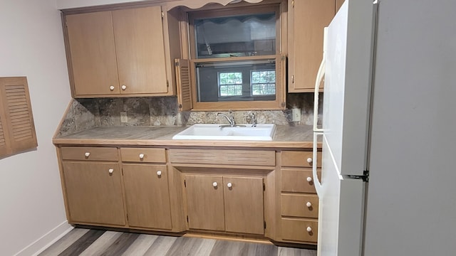 415 N Locust St, Marshfield, MO 65706 - kitchen featuring freestanding refrigerator, a sink, light countertops, and backsplash
