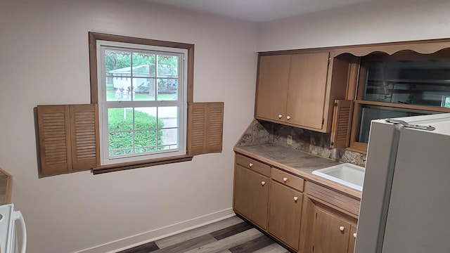 415 N Locust St, Marshfield, MO 65706 - kitchen featuring healthy amount of natural light, light wood-type flooring, baseboards, and a sink