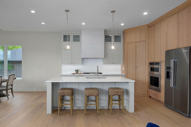 3725 E Woodhue St, Springfield, MO 65802 - kitchen featuring stainless steel appliances, light wood finished floors, light countertops, a sink, and recessed lighting