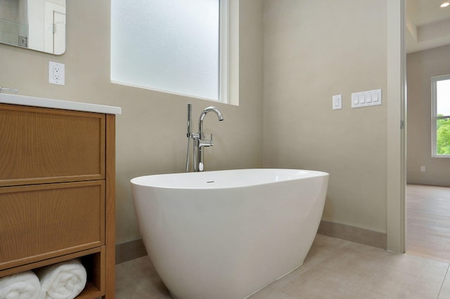 3725 E Woodhue St, Springfield, MO 65802 - bathroom with a freestanding bath, vanity, and baseboards